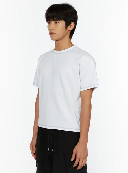 Men's Stitched Cropped T-Shirt IL513 White side view on male model showing cropped silhouette and contrast stitching detail at hem and sleeve