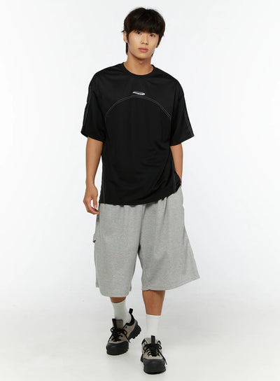 LEWKIN Men's Stitched T-Shirt IL513 Black M/L full-body front shot on male model styled with gray shorts and chunky sneakers