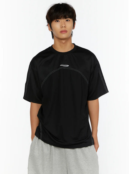 Men's Stitched T-Shirt IL513 Black front cropped shot on male model showing TEAM.BEGIN logo crew neck and white contrast curved stitching