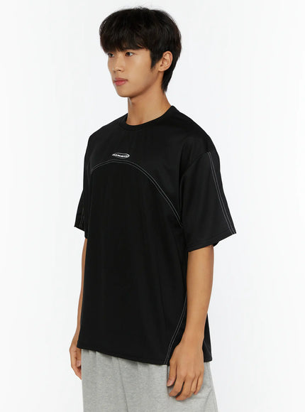 Men's Stitched T-Shirt IL513 Black side shot on male model showing white contrast stitching along sleeve and torso seam detail