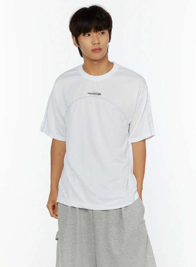 Men's Stitched T-Shirt IL513 White cropped front shot on male model with TEAM.BEGIN logo and contrast stitch seam detail