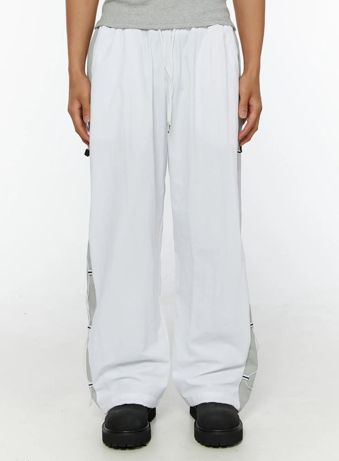Men's String Detail Track Pants IL515 White front view on model cropped at waist showing elastic drawstring waistband and gray side panels with cord trim