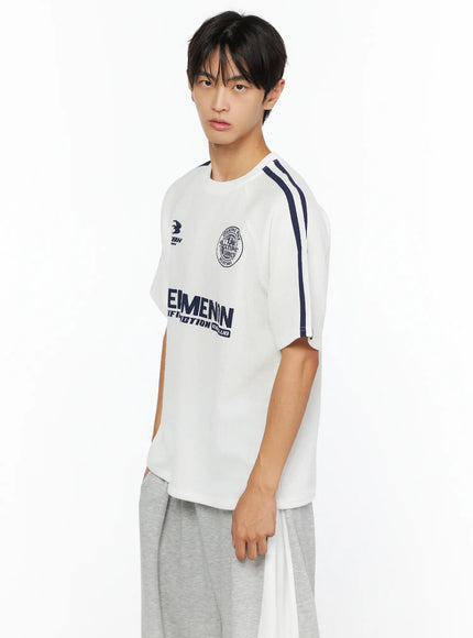 LEWKIN Men's Stripe Detail Tee IL528 White side view on male model wearing grey sweatpants, navy stripe detail on shoulder, ribbed texture