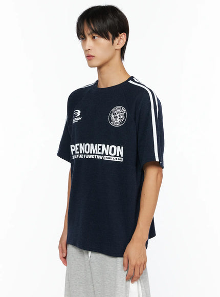 Men's Stripe Detail Tee IL528 Navy side view on male model showing ribbed knit texture, white double shoulder stripes, PHENOMENON chest graphic