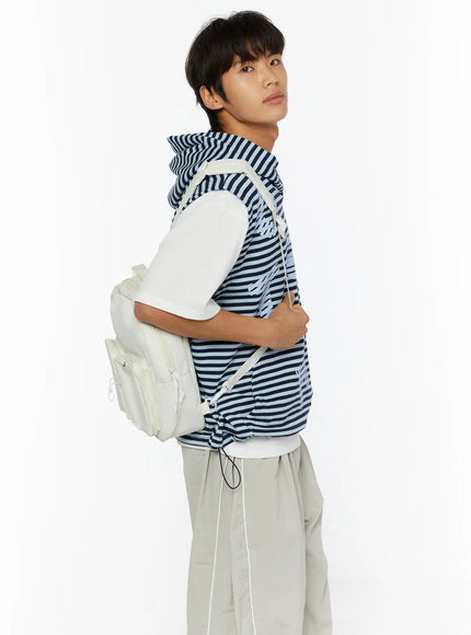 Men's Striped Graphic Hoodie IL510 Light blue side shot on male model wearing white backpack, showing side profile of navy stripe vest with hood and layered white tee