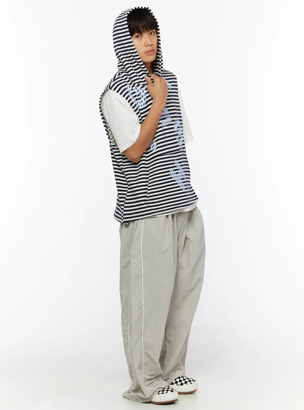 Men's Striped Graphic Hoodie IL510 Light blue side shot on male model with hood up, layered over white tee, styled with grey wide-leg trousers and checkered sneakers