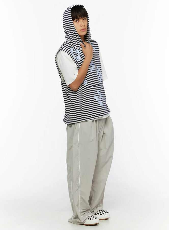 Men's Striped Graphic Hoodie IL510 Light blue side shot on male model with hood up, layered over white tee, styled with grey wide-leg trousers and checkered sneakers