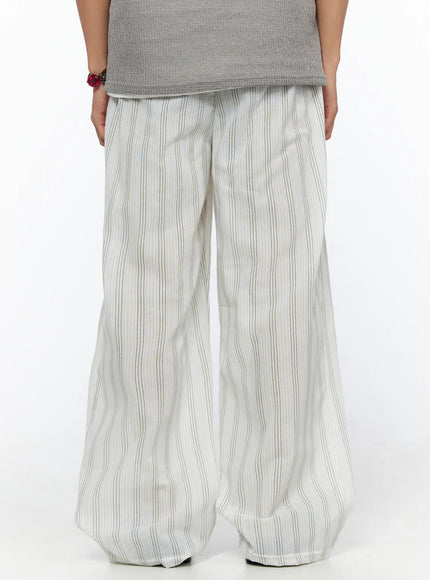 Men's Striped Lounge Pants IL520 Light green back shot on model showing wide-leg silhouette, elastic waistband and vertical multi-stripe linen-blend fabric