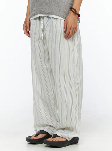 Men's Striped Lounge Pants IL520 Light green angled close-up on model highlighting side silhouette, elastic waist with drawstring, and vertical stripe texture