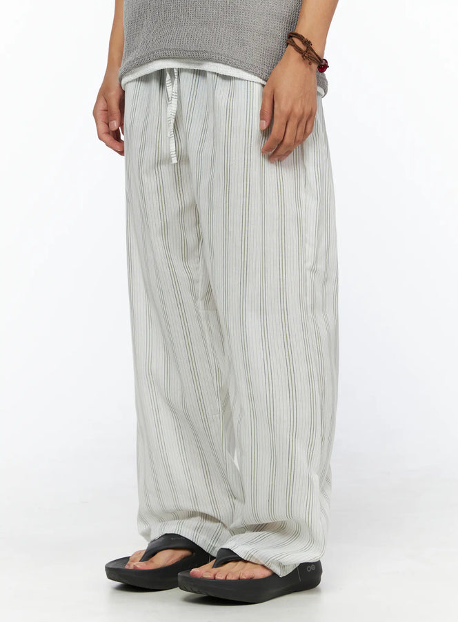Men's Striped Lounge Pants IL520 Light green angled close-up on model highlighting side silhouette, elastic waist with drawstring, and vertical stripe texture