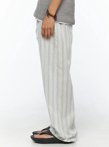 Men's Striped Lounge Pants IL520 Light green side shot on male model showing straight wide-leg profile, elastic waistband and lightweight striped fabric