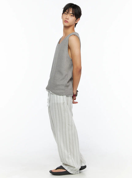 Men's Striped Lounge Pants IL520 Light green full side shot on male model in gray tank styled casually, showing relaxed drape and wide-leg striped trousers