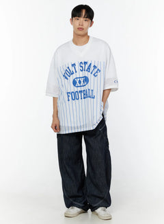 LEWKIN Men's Striped Oversized T-Shirt IU529 White front full-body model shot styled with dark wide-leg jeans and white sneakers, blue VOLT STATE FOOTBALL graphic on mesh fabric