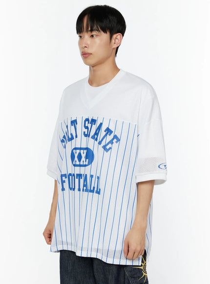 Men's Striped Oversized T-Shirt IU529 White side close-up model three-quarter angle showing blue VOLT STATE FOOTBALL graphic, mesh texture and sleeve logo patch detail