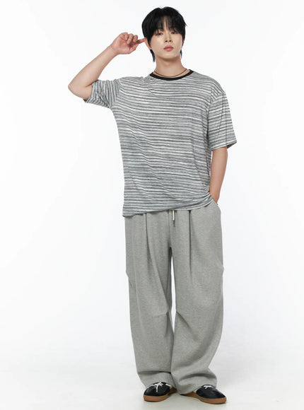 Men's Striped Short Sleeve Tee IL502 Gray full-body front shot on male model one hand raised to temple styled with gray wide-leg sweatpants and loafers