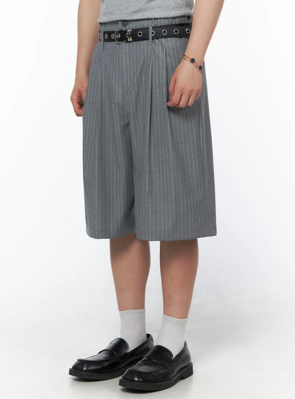 Men's Striped Shorts & Belt Set (Gray) IL502 Gray angled side shot on model showing wide-leg pinstripe shorts silhouette, black grommet belt, chain bracelet detail, black loafers