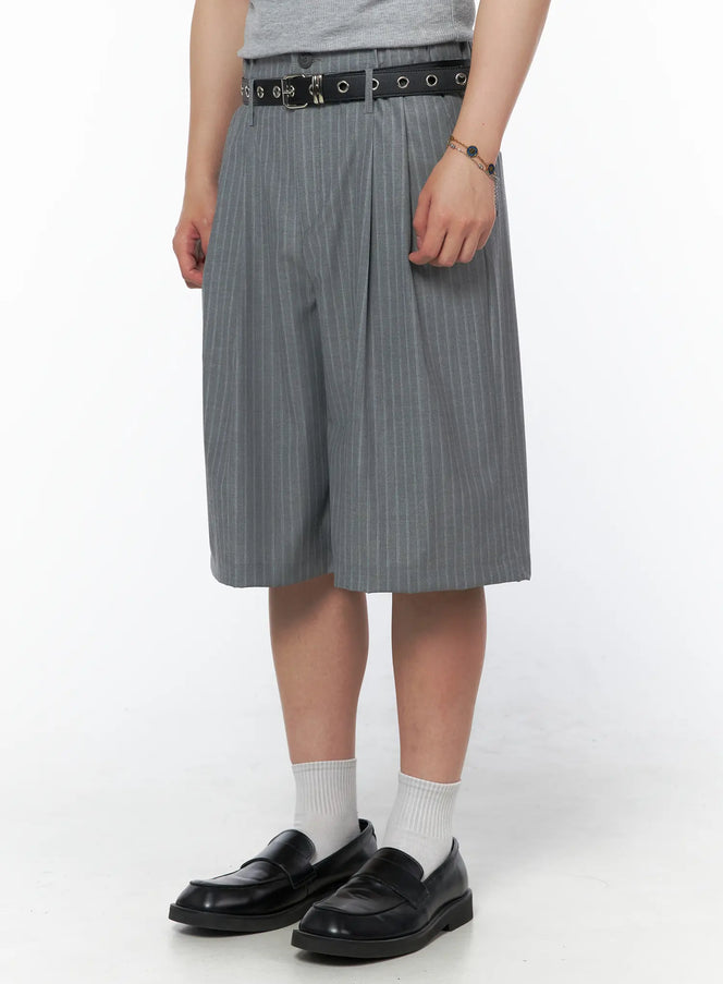 Men's Striped Shorts & Belt Set (Gray) IL502 Gray angled side shot on model showing wide-leg pinstripe shorts silhouette, black grommet belt, chain bracelet detail, black loafers