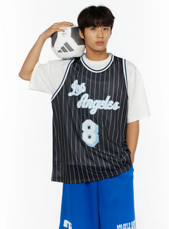 LEWKIN Men's Striped Sleeveless Jersey IL509 Black front close-up on male model holding soccer ball on shoulder, white tee layered underneath, blue shorts