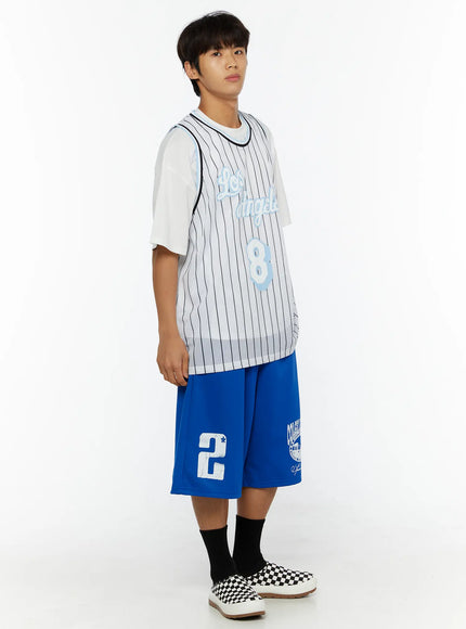 Men's Striped Sleeveless Jersey IL509 White three-quarter side full-body shot on male model, pinstripe mesh jersey over white tee, blue graphic shorts and checkered slip-ons