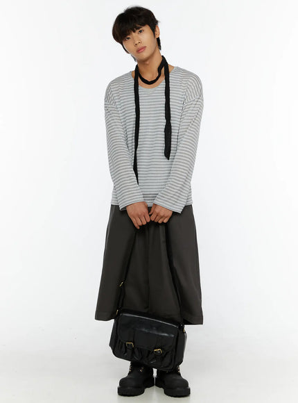 Men's Striped V-Neck Long Sleeve Tee IL515 Gray front shot on model full-body styled with black scarf dark wide-leg pants and boots hands clasped at front