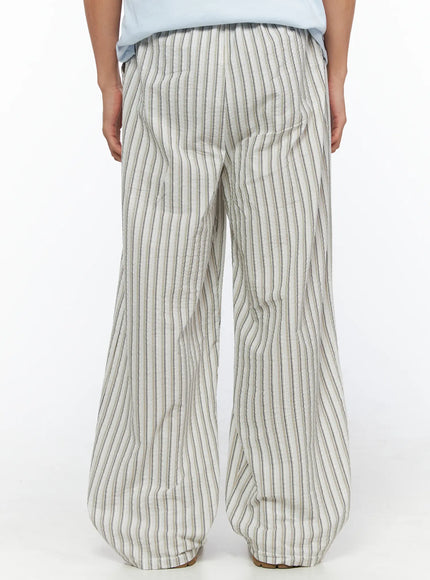 Men's Striped Wide-Leg Pants IL515 Light beige back shot on model showing rear panel of wide-leg striped seersucker pants with elasticated waistband, styled with blue tee