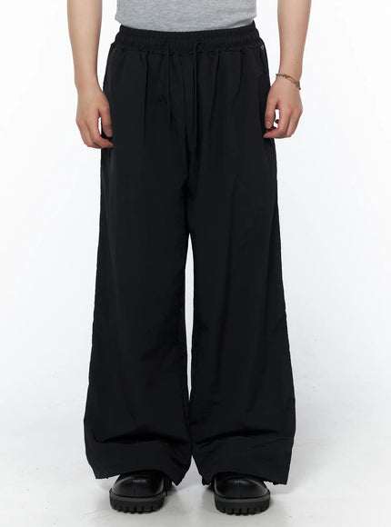 Men's Striped Wide Leg Track Pants IL502 Black front close-up on model showing elastic drawstring waistband and ultra wide leg fit with lightweight fabric