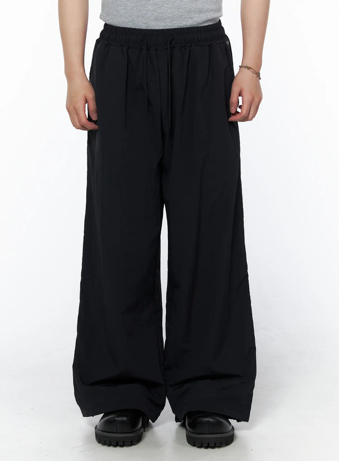 Men's Striped Wide Leg Track Pants IL502 Black front close-up on model showing elastic drawstring waistband and ultra wide leg fit with lightweight fabric