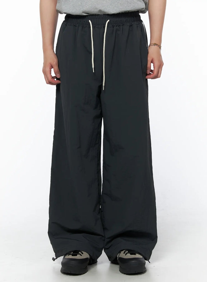 Men's Striped Wide Track Pants IU523 dark gray front view on model showing cream drawstring waist and ankle drawcord hem with wide leg silhouette