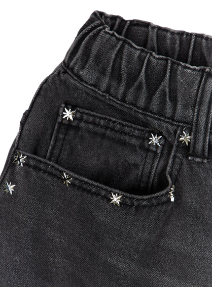 Men's Studded Jorts IL520 Black close-up detail of coin pocket and waistband with silver six-point star studs on washed black denim