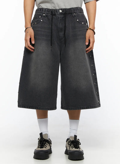 LEWKIN Men's Studded Jorts IL520 Black front view on model wearing gray tee, wide-leg washed denim shorts with silver star studs