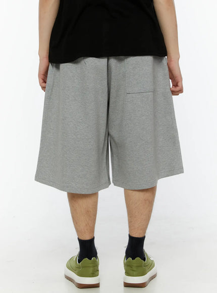 Men's Sun Embroidered Shorts (Gray) IL509 Gray back view on model showing clean plain back panel, single back patch pocket, elastic drawstring waist, and wide-leg hem