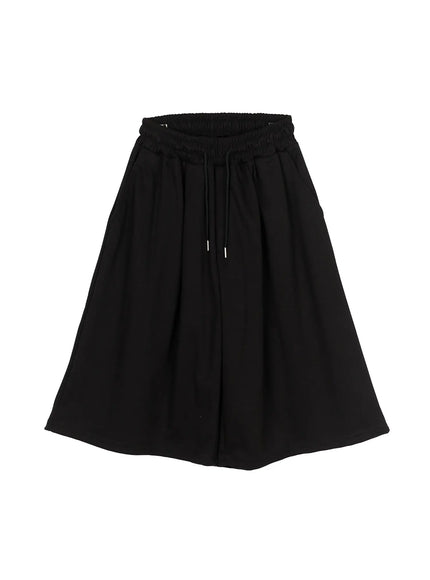 Men's Swirl Print Back Pocket Shorts (Black) IL509 Black flat-lay back view showing swirl graphic print on back patch pocket elastic waistband and wide balloon-leg shape