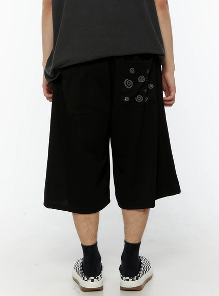 Men's Swirl Print Back Pocket Shorts (Black) IL509 Black detail close-up of back patch pocket featuring gray swirl pattern print scattered across pocket on cotton fabric