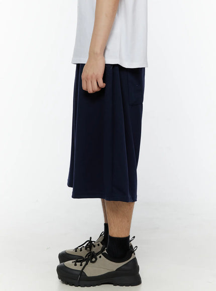 Men's Swirl Print Back Pocket Shorts (Dark Blue) IL509 Dark Blue right-side view on male model showing side seam pocket placement and wide-leg drop crotch silhouette