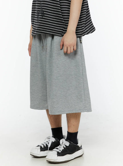 Men's Swirl Print Back Pocket Shorts (Gray) IL509 Gray side view on model showing drawstring waist with metal tip and clean straight silhouette paired with striped top