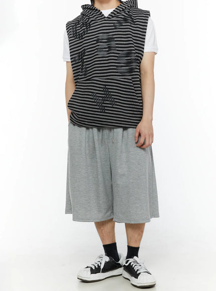Men's Swirl Print Back Pocket Shorts (Gray) IL509 Gray full-body front view on model styled with striped sleeveless hoodie and white sneakers showing relaxed wide-leg fit