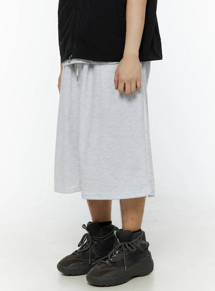 Men's Swirl Print Back Pocket Shorts (Light Gray) IL509 left side view on model showing wide-leg drape elastic waist and relaxed midi length with side seam detail