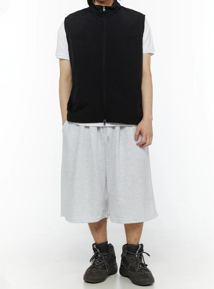 Men's Swirl Print Back Pocket Shorts (Light Gray) IL509 full front view on model styled with black zip vest and white tee showing oversized boxy fit