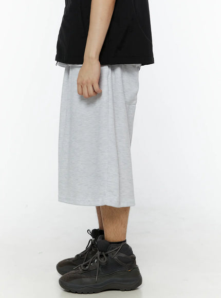 Men's Swirl Print Back Pocket Shorts (Light Gray) IL509 right side view on model showing wide-leg silhouette drop inseam and heathered gray fleece texture
