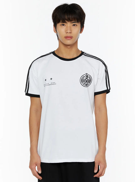 Men's Track Graphic T-Shirt IL507 White front view on model, black three-stripe shoulders, black rib trim, black eagle crest and World Championship print, black pants