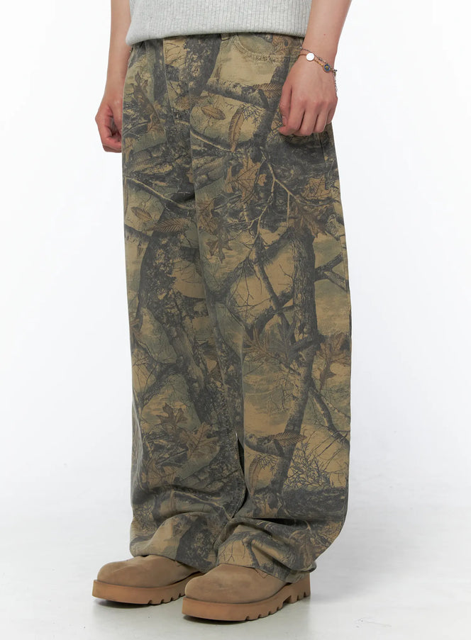 Men's Tree Graphic Wide Leg Pants IL502 Beige side close-up on model showing wide leg hem, pocket detail and tree branch camo print texture