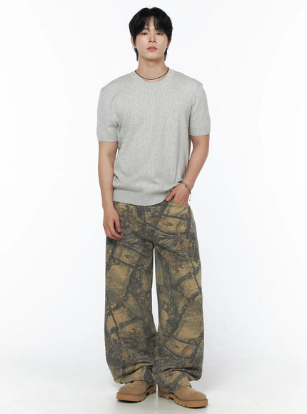 Men's Tree Graphic Wide Leg Pants IL502 Beige full front shot on male model standing upright styled with gray ribbed knit tee and tan chunky boots