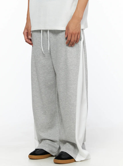LEWKIN Men's Two-Tone Sweatpants IL528 Gray size M/L close-up side shot on model showing white side panel drawstring waist and wide-leg fleece silhouette