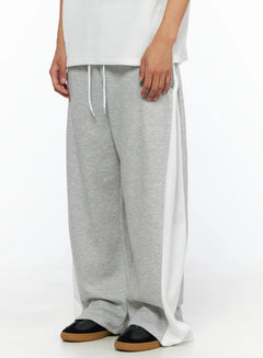 LEWKIN Men's Two-Tone Sweatpants IL528 Gray size M/L close-up side shot on model showing white side panel drawstring waist and wide-leg fleece silhouette