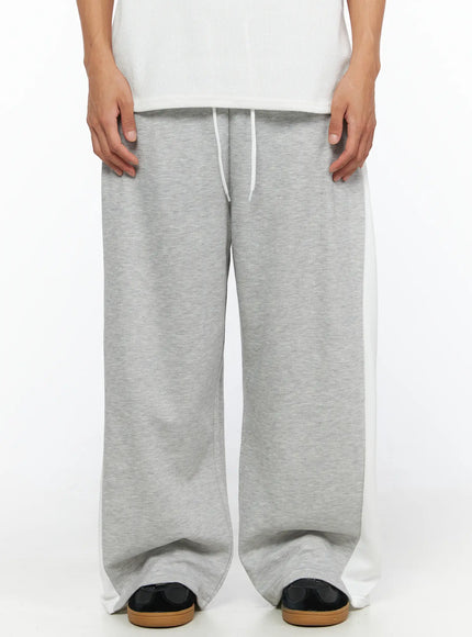 Men's Two-Tone Sweatpants IL528 Gray front close-up on model showing elastic drawstring waistband gray marl fabric and white contrast side panels wide-leg fit