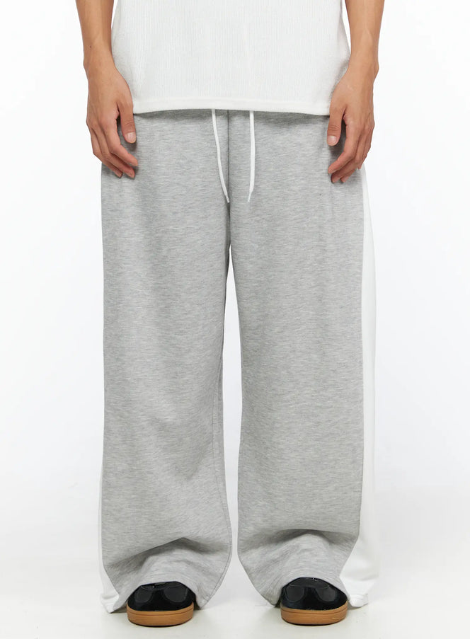 Men's Two-Tone Sweatpants IL528 Gray front close-up on model showing elastic drawstring waistband gray marl fabric and white contrast side panels wide-leg fit