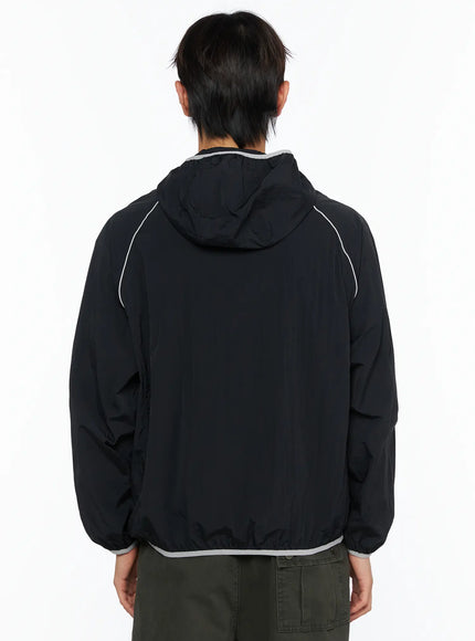 Men's Two-Tone Windbreaker IL528 Black back view on male model, showing hood construction, raglan seams with contrast piping, grey hem trim