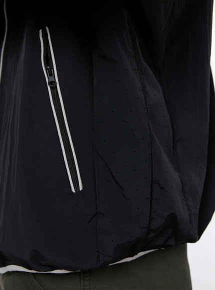 Men's Two-Tone Windbreaker IL528 Black close-up detail of side zip pocket with white reflective piping trim and perforated nylon fabric texture