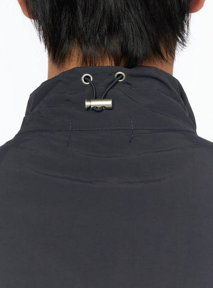 Men's Two-Way Anorak Vest IL515 Dark gray close-up back neck detail showing adjustable drawcord with metal cord stopper on nylon fabric