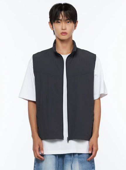 Men's Two-Way Anorak Vest IL515 Dark gray cropped front shot on male model showing stand collar, center zip closure, and panel seam construction